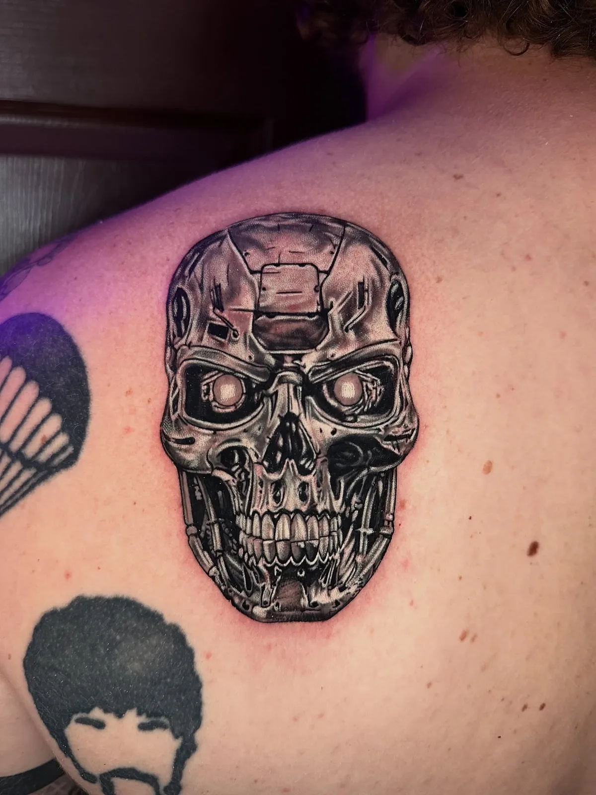 Detailed black and grey cyborg skull tattoo