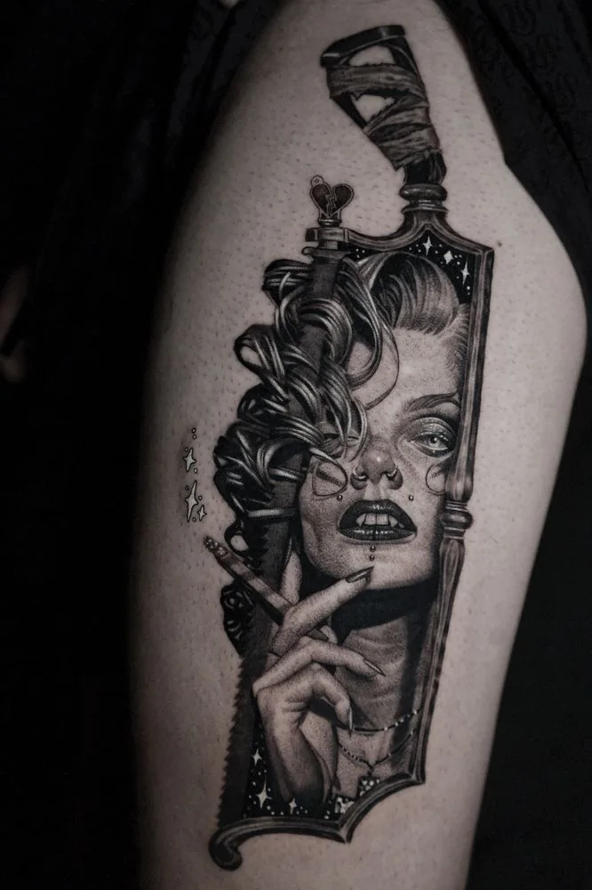 Black and grey surreal woman portrait reflected in a hand mirror